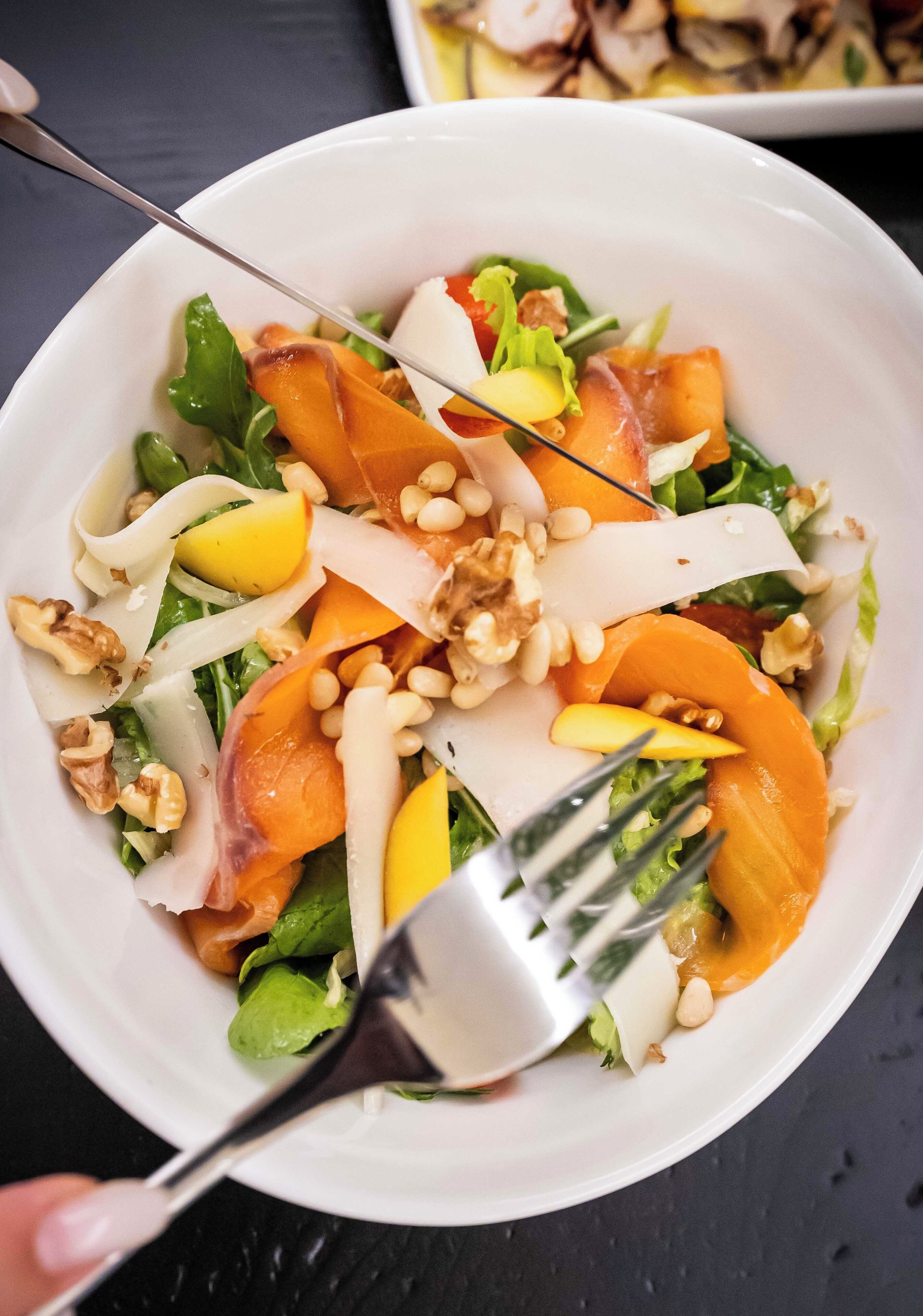 A bowl of salad with various ingredients.