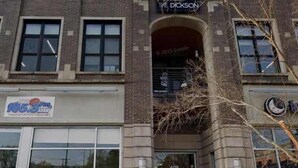 A multi-story building with a storefront on the ground floor.