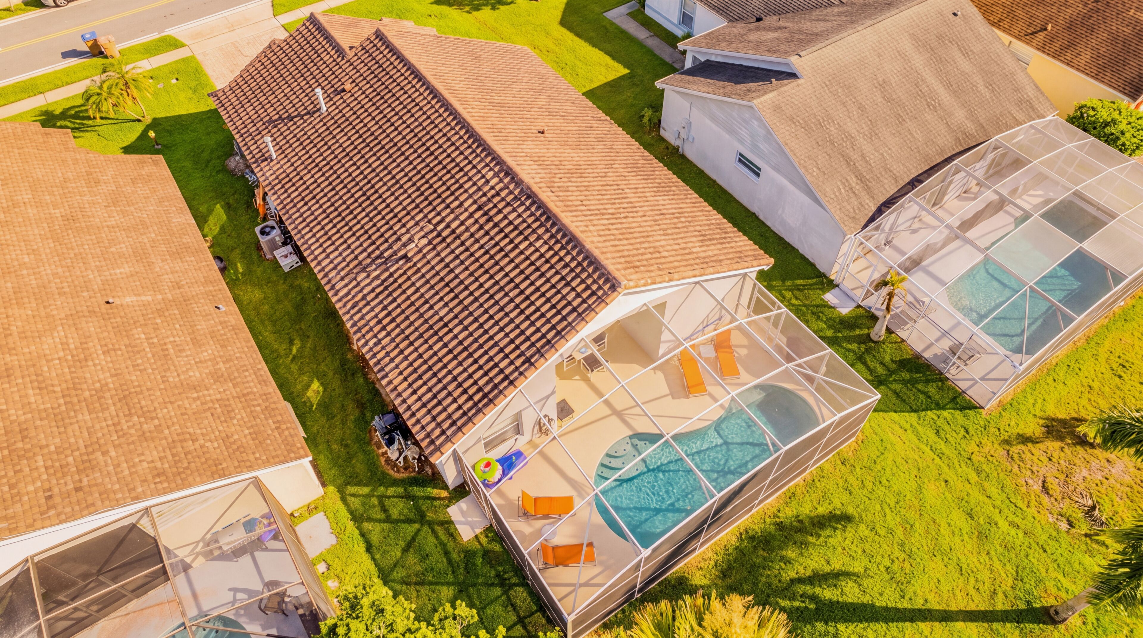A large house with a swimming pool, a greenhouse, and a garage.