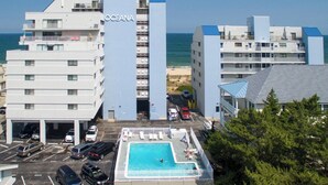 A hotel named 'OCEANA' with a swimming pool, parking area, and a view of the beach. - Wonderful Ocean Views from this 2 Bedroom Oceanfront With a Pool (Ocean City)