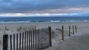 A beach with a wooden fence and a sandy path leading to the ocean. - Wonderful Ocean Views from this 2 Bedroom Oceanfront With a Pool (Ocean City)