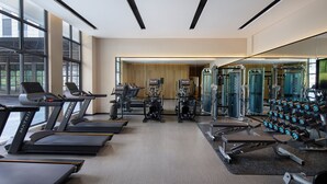 A modern gym with treadmills, weight machines, and free weights. - Fairfield By Marriott Yangshuo (Guilin)