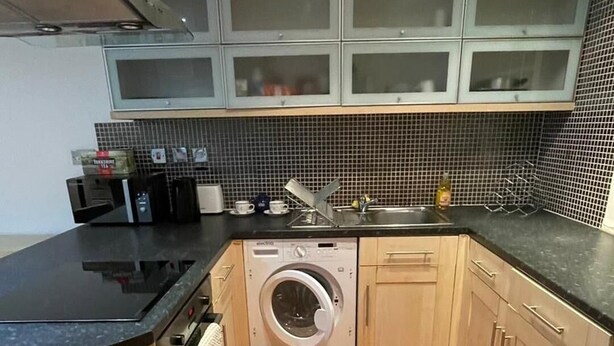 A compact kitchen with a washing machine, a sink, and a microwave. - 1br-wifi-freesnacks-freeparking-petsok-retroarcade (Newcastle-upon-Tyne)