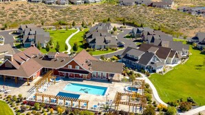 Un barrio residencial con casas, una piscina y un césped bien cuidado.