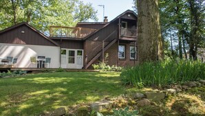 A two-story house with a wooden deck and a brick exterior. - 1st flr nr Shaker, RTA rail, Cle Clinic & Univ. Ho (Akron)