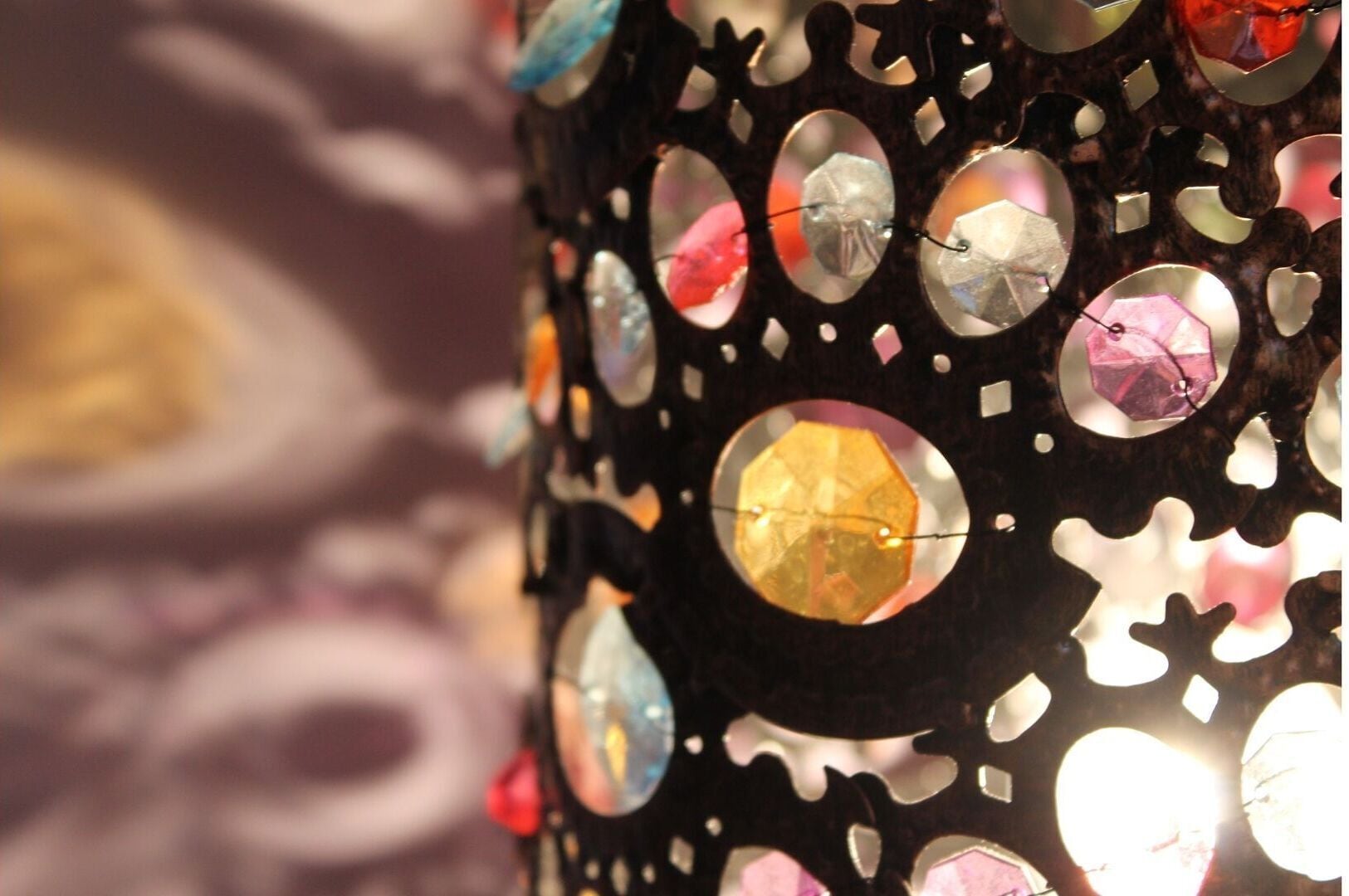 A decorative wall with circular cutouts and embedded reflective surfaces.