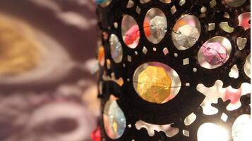 A decorative wall with circular cutouts and embedded reflective surfaces.