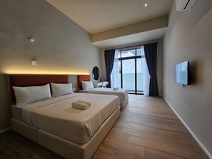 A hotel room with a large bed, a TV, a bedside table, and a window with curtains. - Room at Weld Quay Georgetown (George Town)