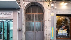 A storefront with a metal gate and a sign reading "Celleria Giuliani". - Dimora Sergente Maggiore By DomusExtra (Naples)