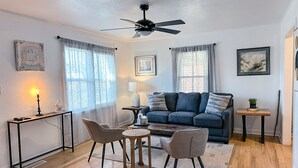 A modern living room with a sofa, two chairs, a coffee table, a ceiling fan, and a small side table. - Affordable 2BR Getaway Near Plaza District Lilac1 (Midwest City)