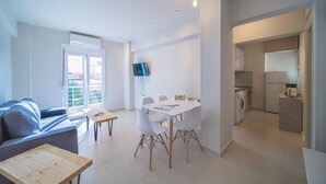 A modern apartment with a living area, dining space, and kitchen. - City Center Apartment Project 3 by Cretan Houses (Heraklion)