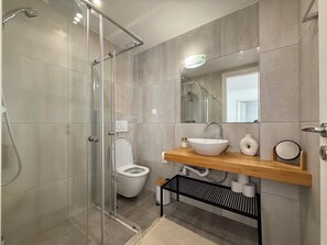Shower, hair dryer, towels, toilet paper