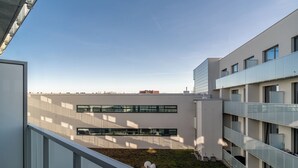 A modern building with a flat roof, large windows, and a small grassy area. - RentPlanet - Studio Zwycięska (Wroclaw)