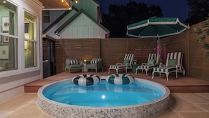 A backyard with a hot tub, outdoor seating, and a wooden deck. - Vivid ATX Vibes | Pools. Personality. Pure Bliss! (Austin)