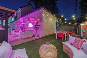 A modern outdoor living space with a covered patio, outdoor furniture, and string lights. - Vivid ATX Vibes | Pools. Personality. Pure Bliss! (Austin)