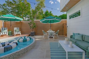 A backyard with a swimming pool, outdoor furniture, and string lights. - Vivid ATX Vibes | Pools. Personality. Pure Bliss! (Austin)