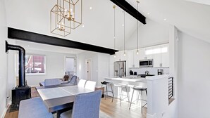 A modern kitchen with white cabinets, stainless steel appliances, and pendant lighting. - Charming Mountain Retreat in the Heart of Frisco (Frisco)