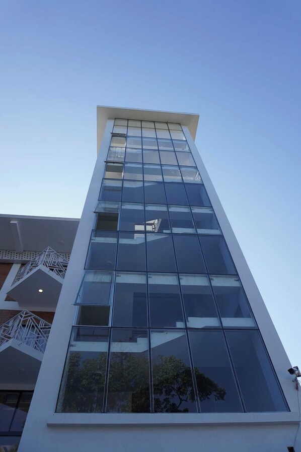 A modern building with a glass facade and a white exterior.