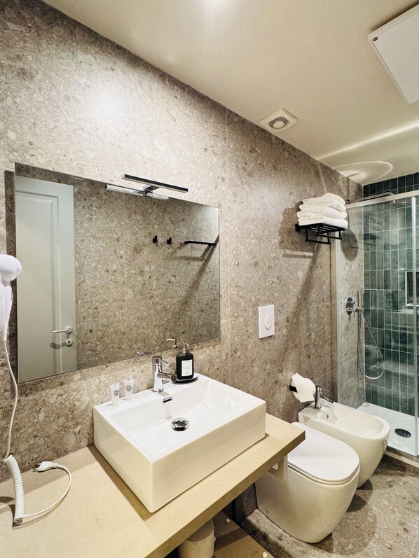 A bathroom with a large sink, two toilets, a shower, and a mirror. - HoneyComb GuestHouse (Rome)
