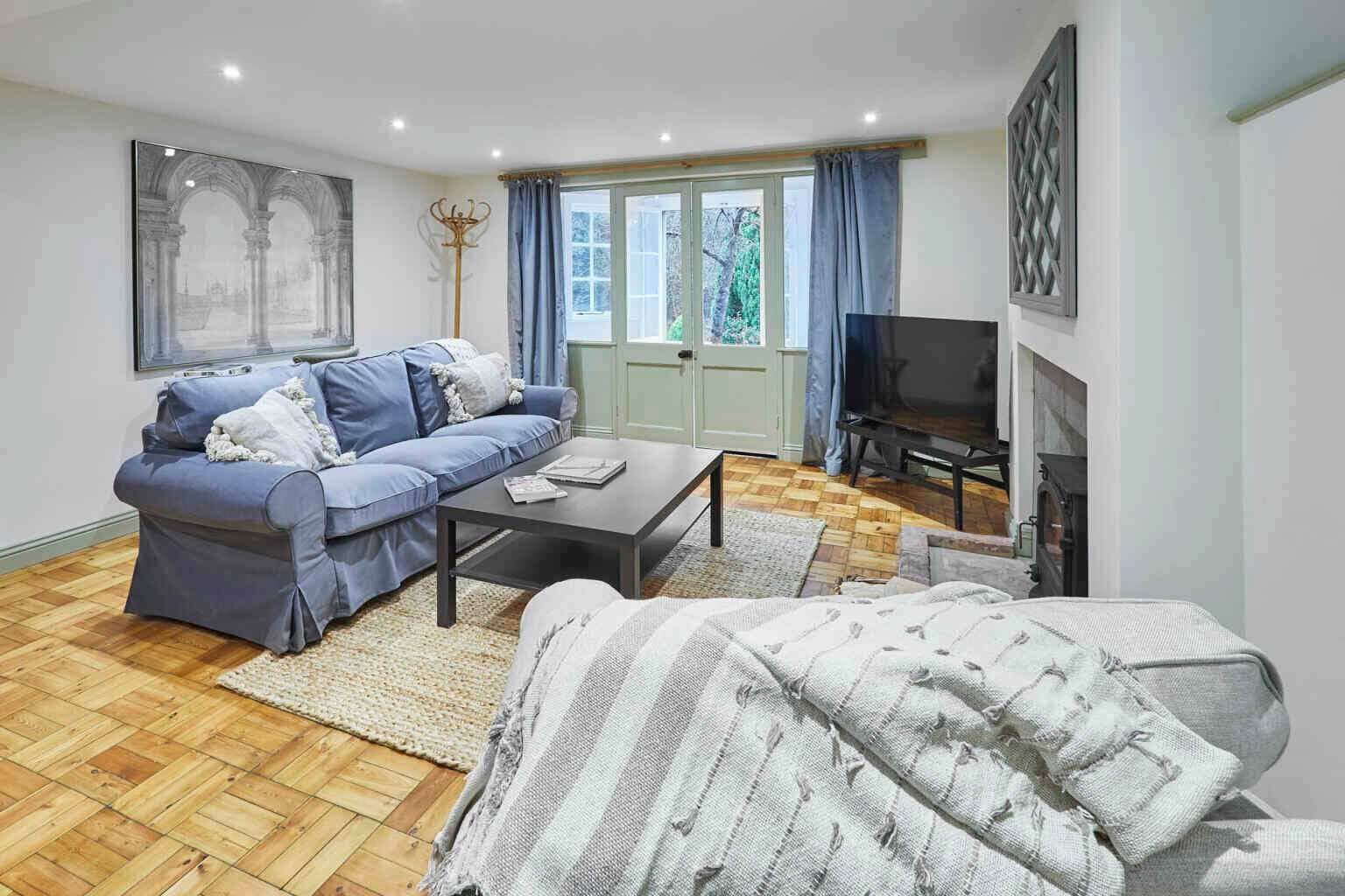 A living room with a sofa, coffee table, and a television.