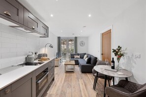 Enjoy a comfortable stay in this well-appointed living space with a kitchen, dining area, and cozy seating area.