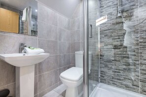 Shower, hair dryer, towels, shampoo