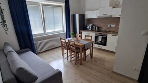 A modern apartment with a living area, dining space, and kitchen. - Apartmá Gabriela (Brno)
