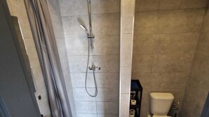 A bathroom with a shower, toilet, and sink. - Apartmá Gabriela (Brno)