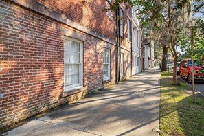 Stroll along a quiet, tree-lined street lined with brick buildings featuring large windows.