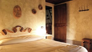 Un dormitorio con una cama grande, cabecera de madera y un armario de madera.