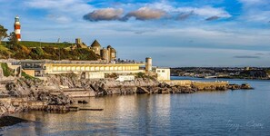 A coastal town with a lighthouse, historic buildings, and a bridge over the water. - Seafront Cottage - Beach Access - Pet Friendly (Plymouth)