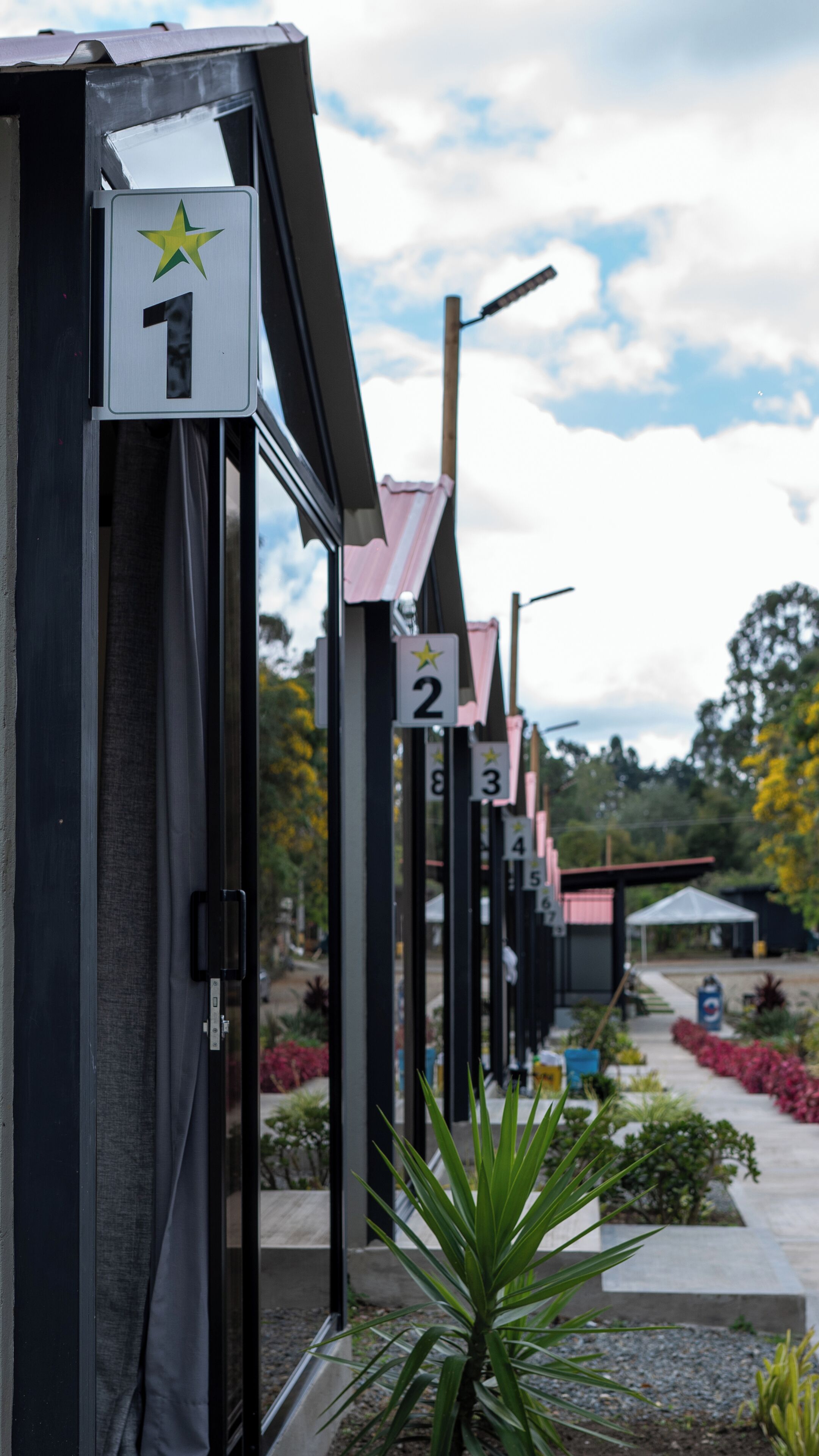 A row of numbered rooms with a star symbol, each with a door and a window.