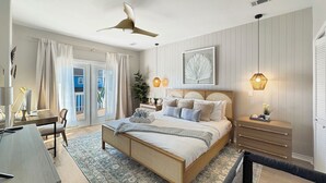 Ein modernes Schlafzimmer mit einem großen Bett, einem Schreibtisch und einem Stuhl. Ein Fenster mit Vorhängen, ein Deckenventilator und eine Wandleuchte sind ebenfalls vorhanden.