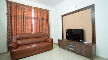 Deluxe Room, Balcony, City View | Living area | Flat-screen TV