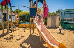 Children can play safely in this enclosed area with a slide and climbing elements.