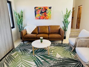 Relax in this inviting living space with a comfortable sofa, coffee table, and cozy seating area.