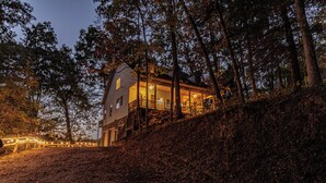 A house with a porch, surrounded by trees and a hill. - Mountain Views, Game Room, Firepit and Hot Tub in Bryson City (Bryson City)