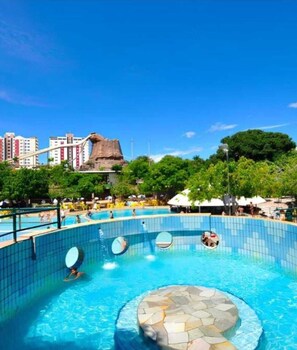 Relax by the large pool surrounded by a tiled deck and a unique stone feature.