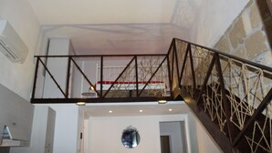 A staircase with a metal railing and a view of a bridge in the background. - First-floor housing located within the city's Ancient Walls. (Castellammare del Golfo (TP))