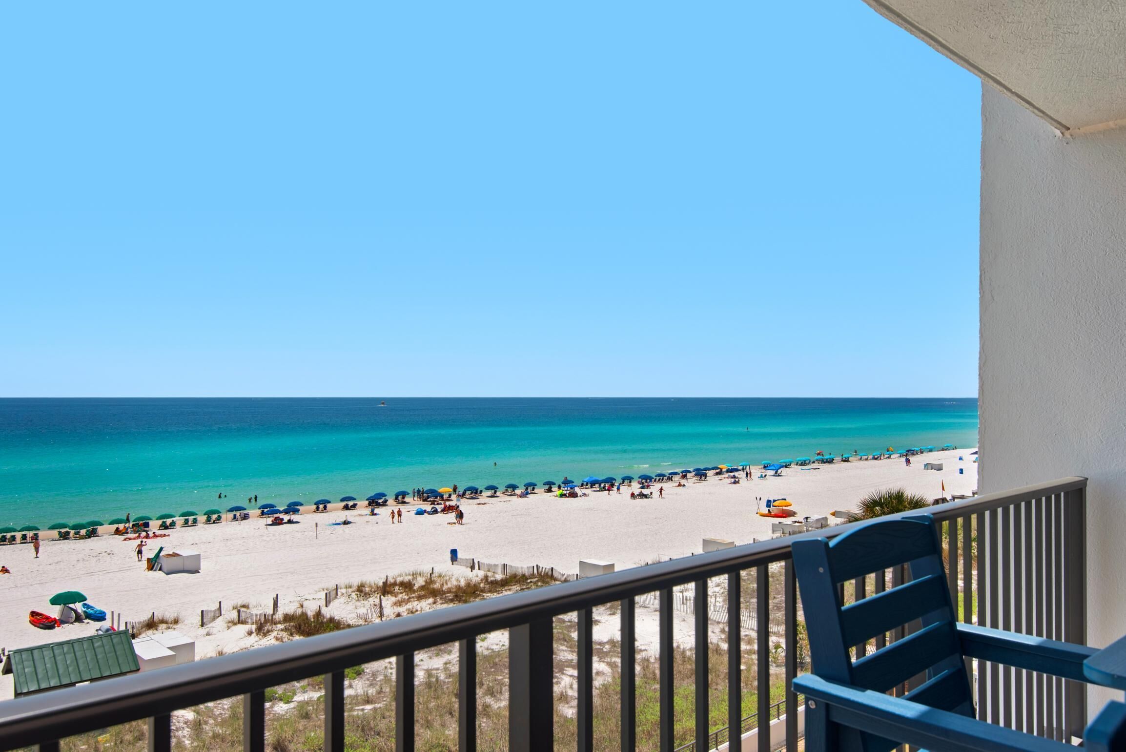 A balcony with a view of a beach.