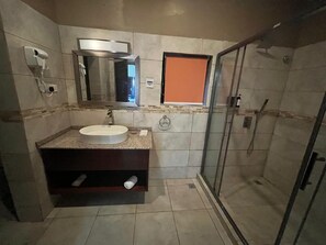Deluxe Room, Sea View | Bathroom | Shower, hair dryer, slippers, towels