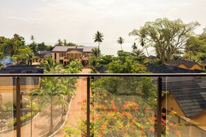 A residential area with houses, a pathway, and a view of the sea.