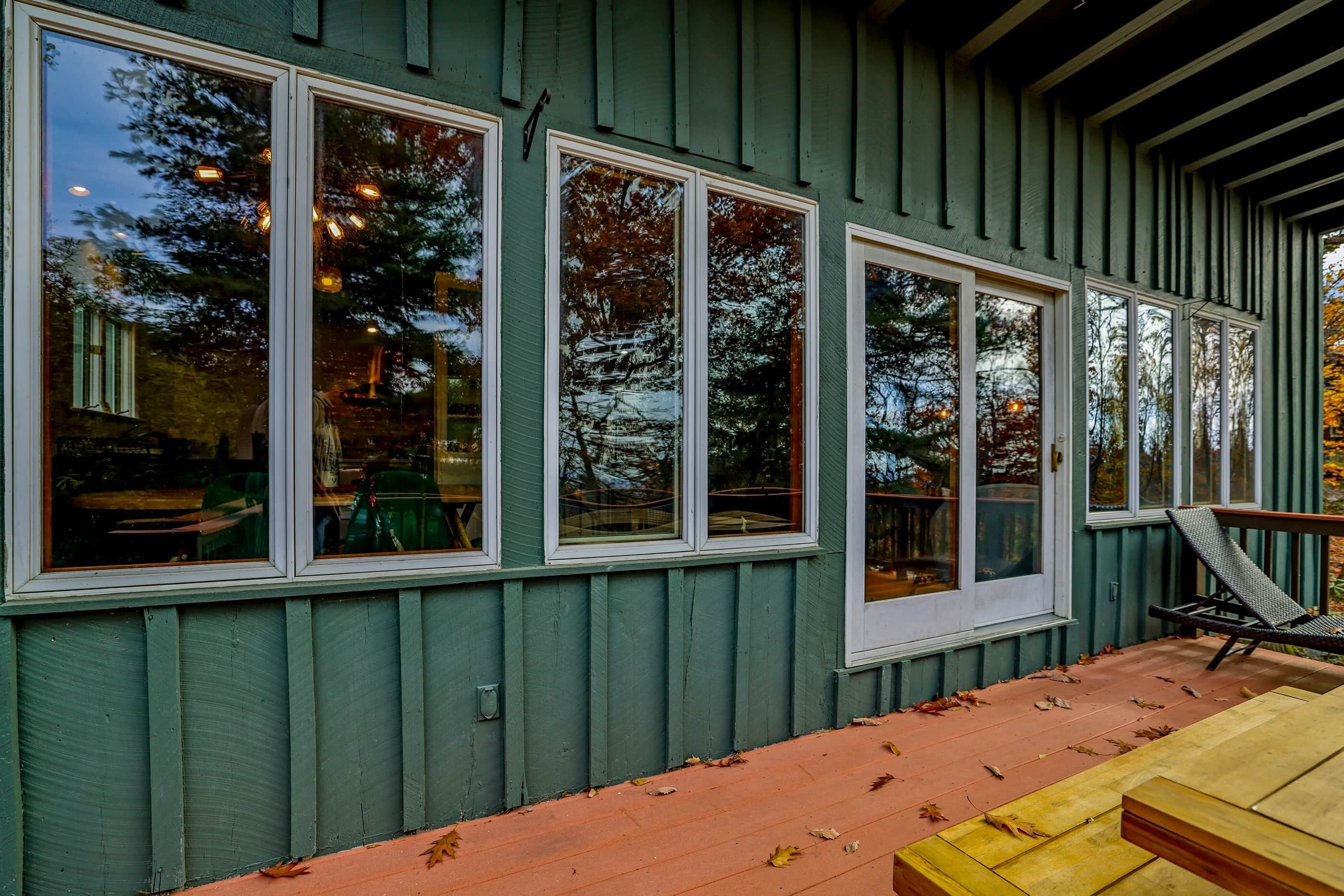 A building with large windows and a wooden deck.