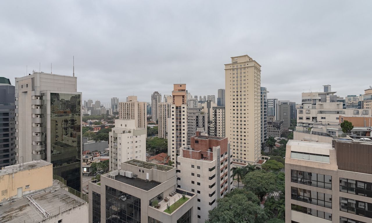 A high-rise urban area with multiple buildings, including a prominent beige skyscraper and several modern structures.