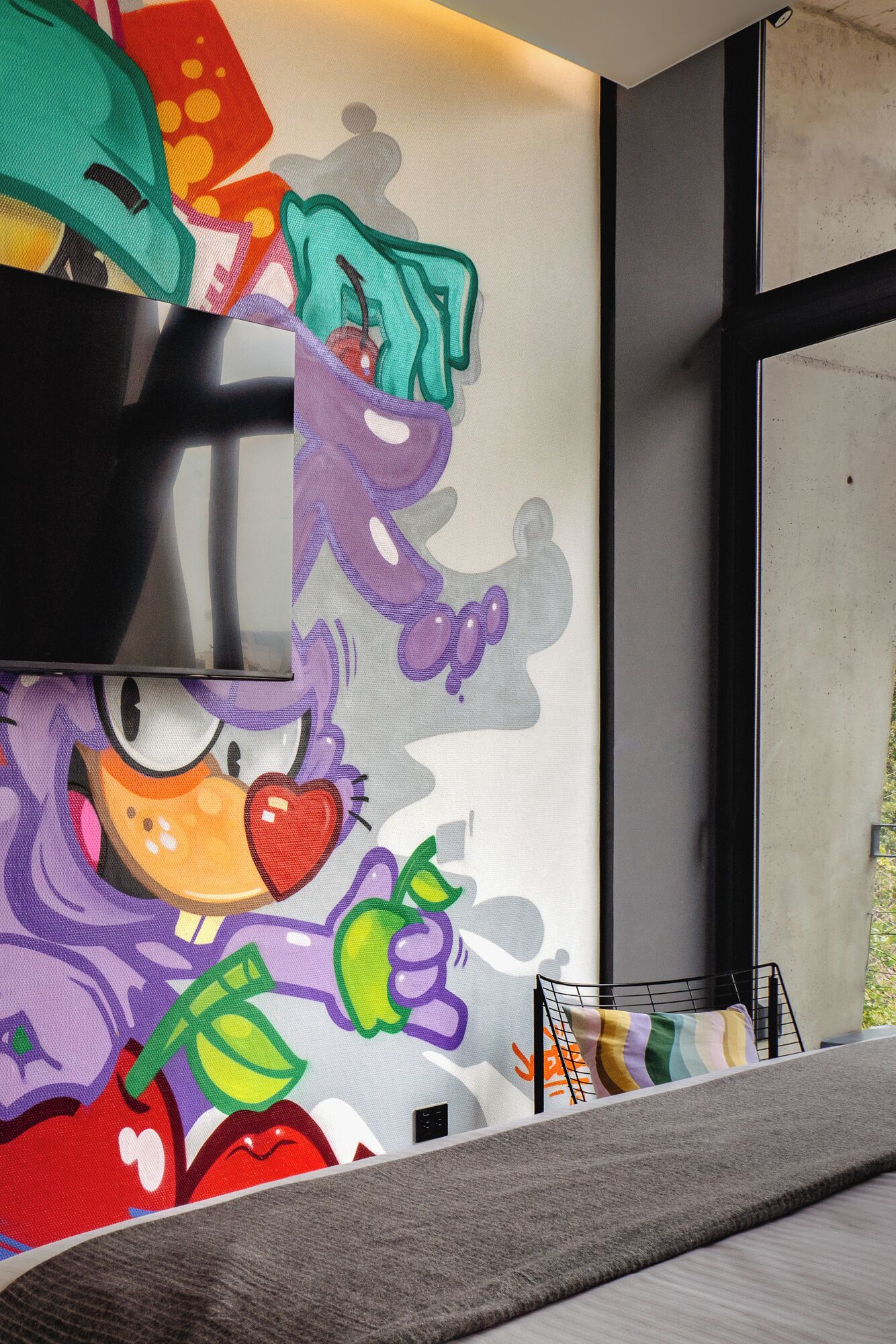 A colorful mural with a cartoon character on a wall.