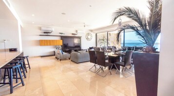 Luxury Condo, Ocean View | Living area | Flat-screen TV