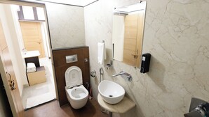 A bathroom with a toilet, sink, and mirror. - BALAJI HOMESTAY VARANASI (Varanasi)