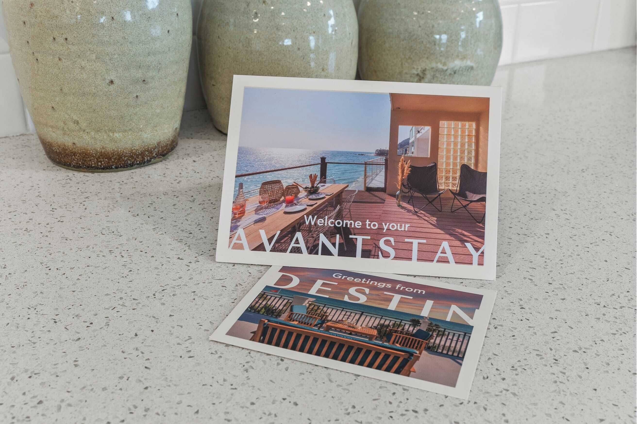 A postcard with a coastal view and text welcoming to 'AVANTSTAY'.