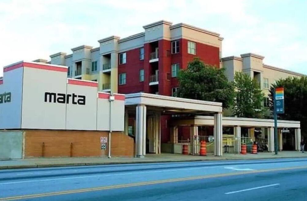 A multi-story building with a 'marta' sign, indicating a hotel or similar establishment.