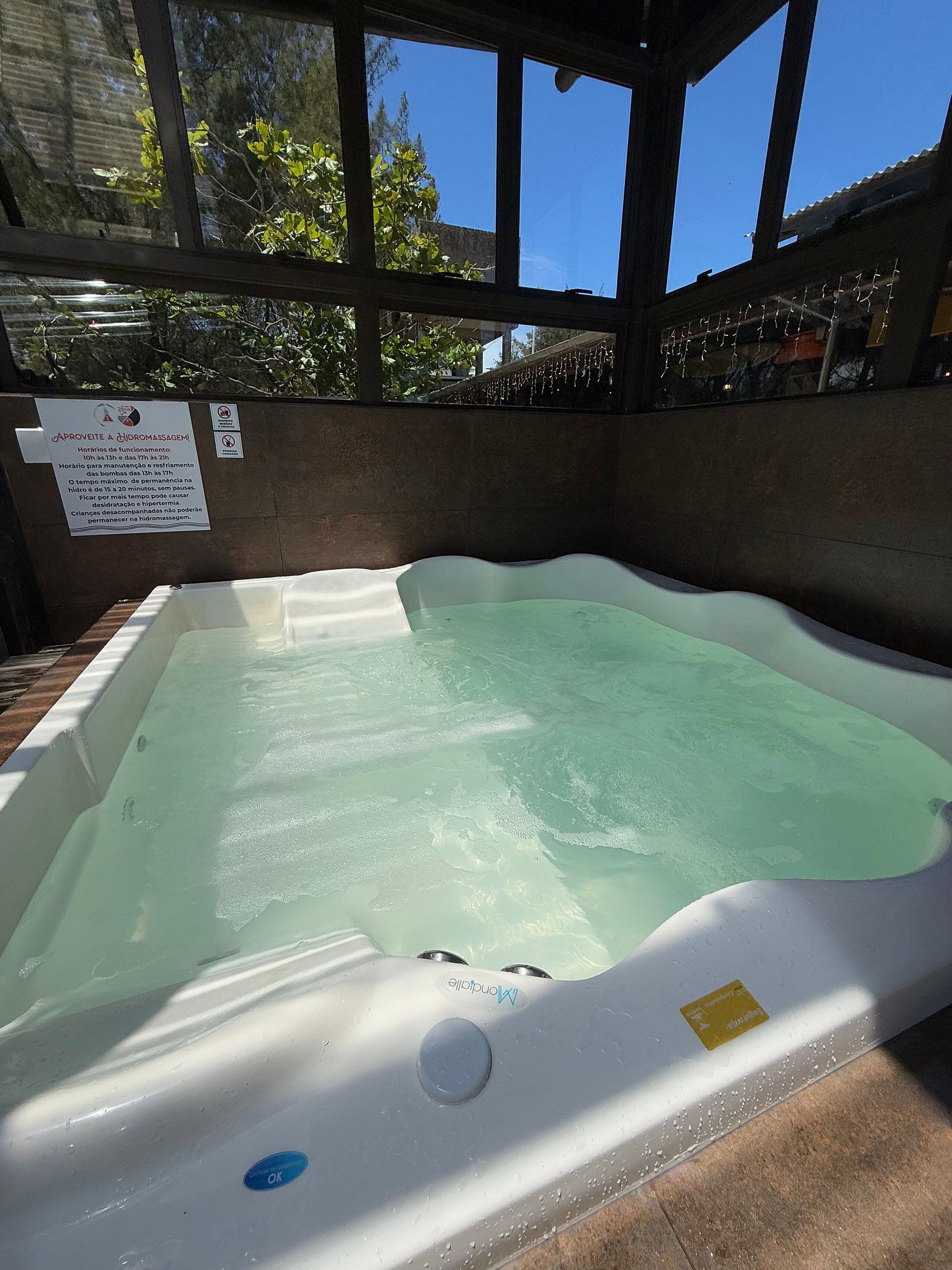 A hot tub with a sign indicating its use for hydrotherapy.